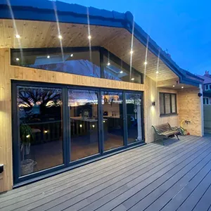 a house with a deck and lights on it