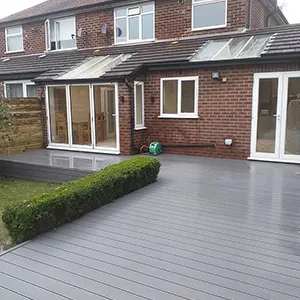 a house with a wooden deck and a garden area