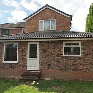 a brick house with a white door and windows