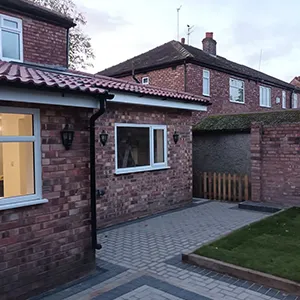 a brick house with a patio and a brick walkway