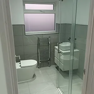a bathroom with a toilet and a shower stall