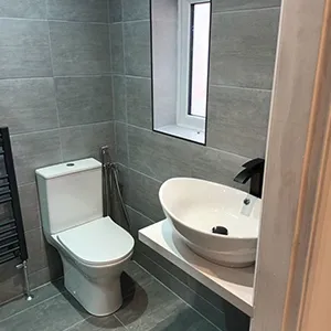 a white toilet sitting next to a white sink