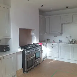 a kitchen with a stove, oven, and cabinets